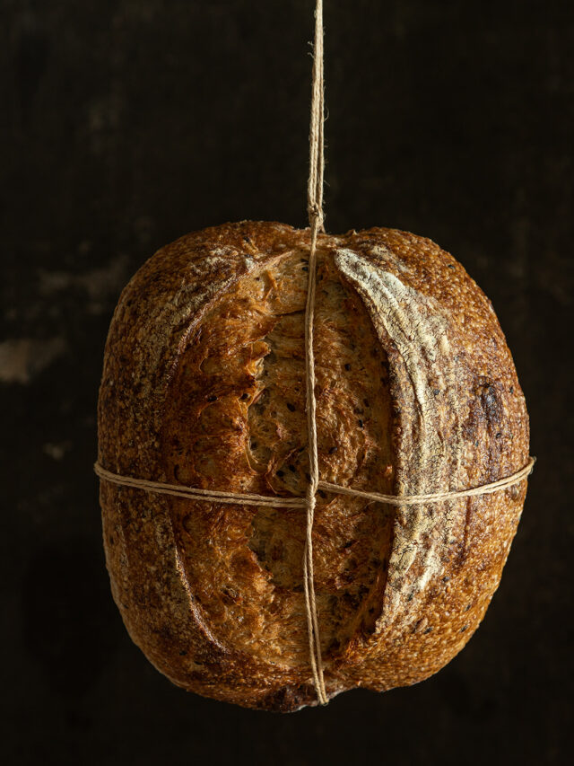Sourdough bread. Front view in a dark background